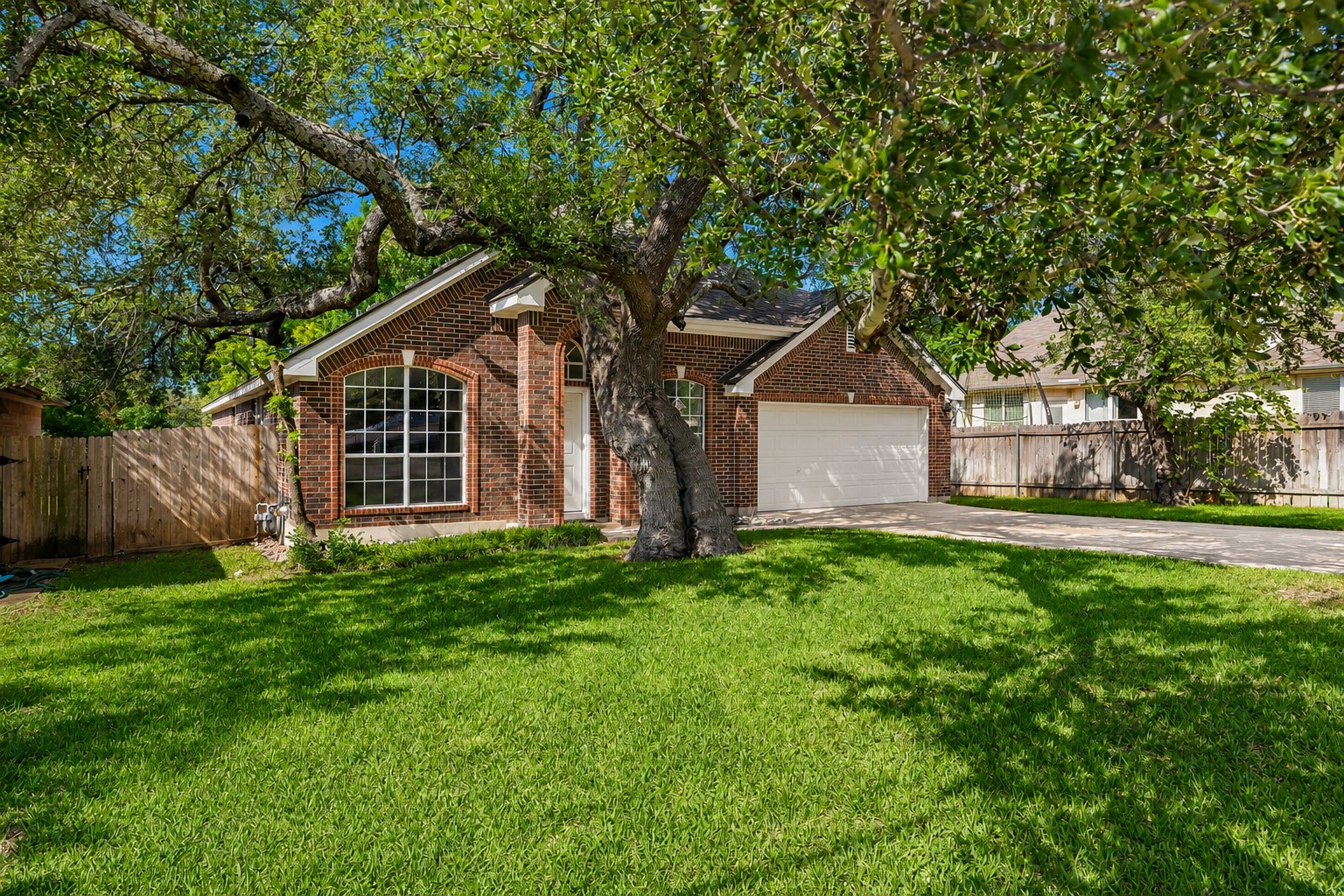 1102 Nelson Ranch Road Cedar Park, TX 78613 - Photo 2 of 37 Mature trees shade this charming brick home, complete with an attached garage and privacy fence.