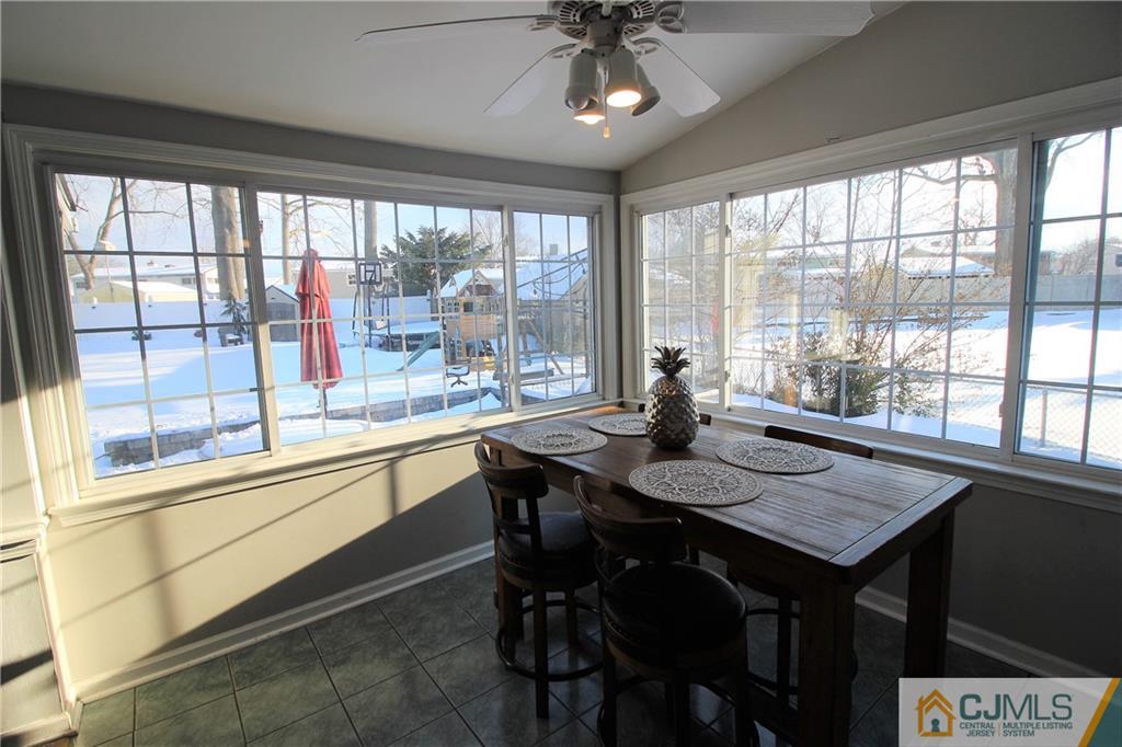 21 Lancaster Road Colonia, NJ 07067 - Photo 4 of 26 a view of a dining room with furniture large windows and wooden floor