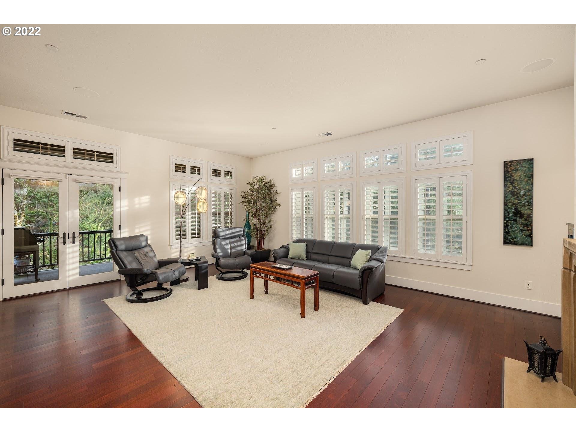 10460 Southwest Windwood Way Portland, OR 97225 - Photo 11 of 29 a living room with furniture wooden floor and floor to ceiling windows