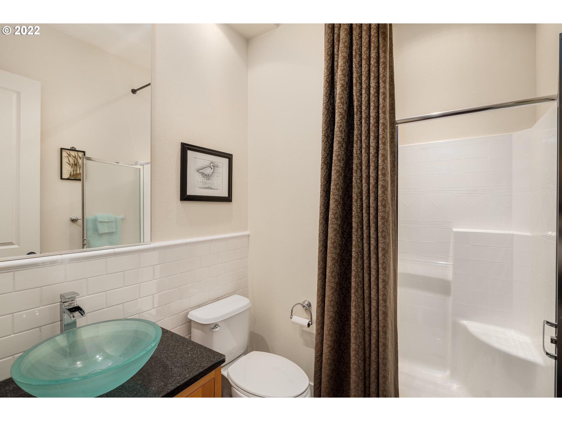 10460 Southwest Windwood Way Portland, OR 97225 - Photo 14 of 29 a bathroom with a toilet a sink and mirror