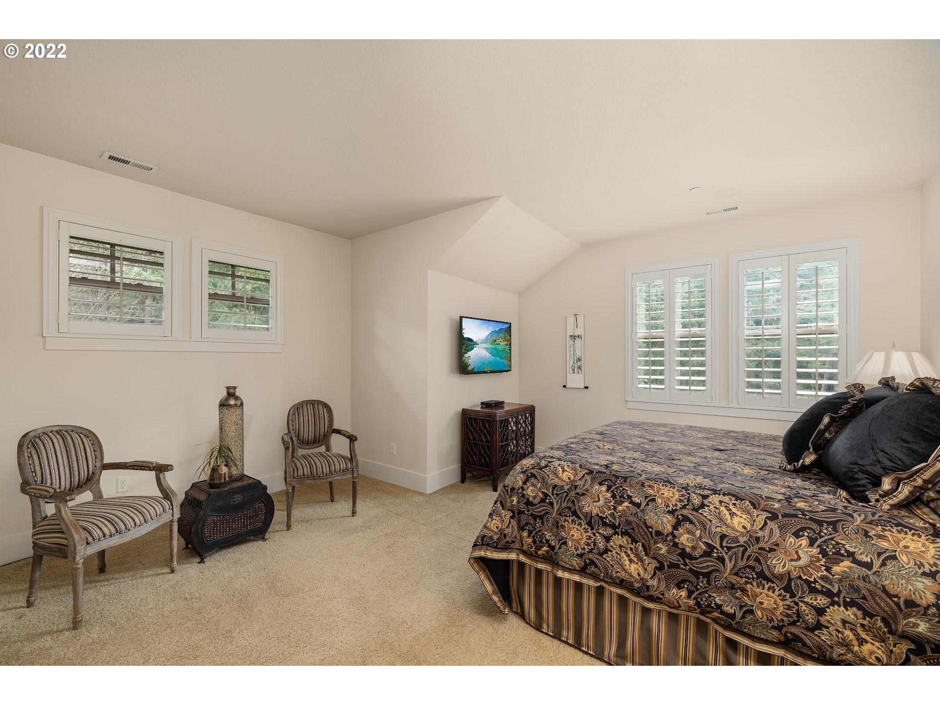 10460 Southwest Windwood Way Portland, OR 97225 - Photo 15 of 29 a bedroom with a bed a table and chair