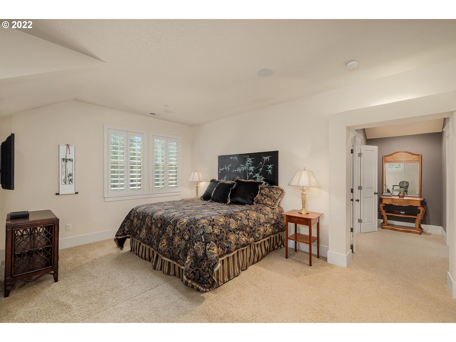 10460 Southwest Windwood Way Portland, OR 97225 - Photo 16 of 29 a bedroom with a bed and a tv