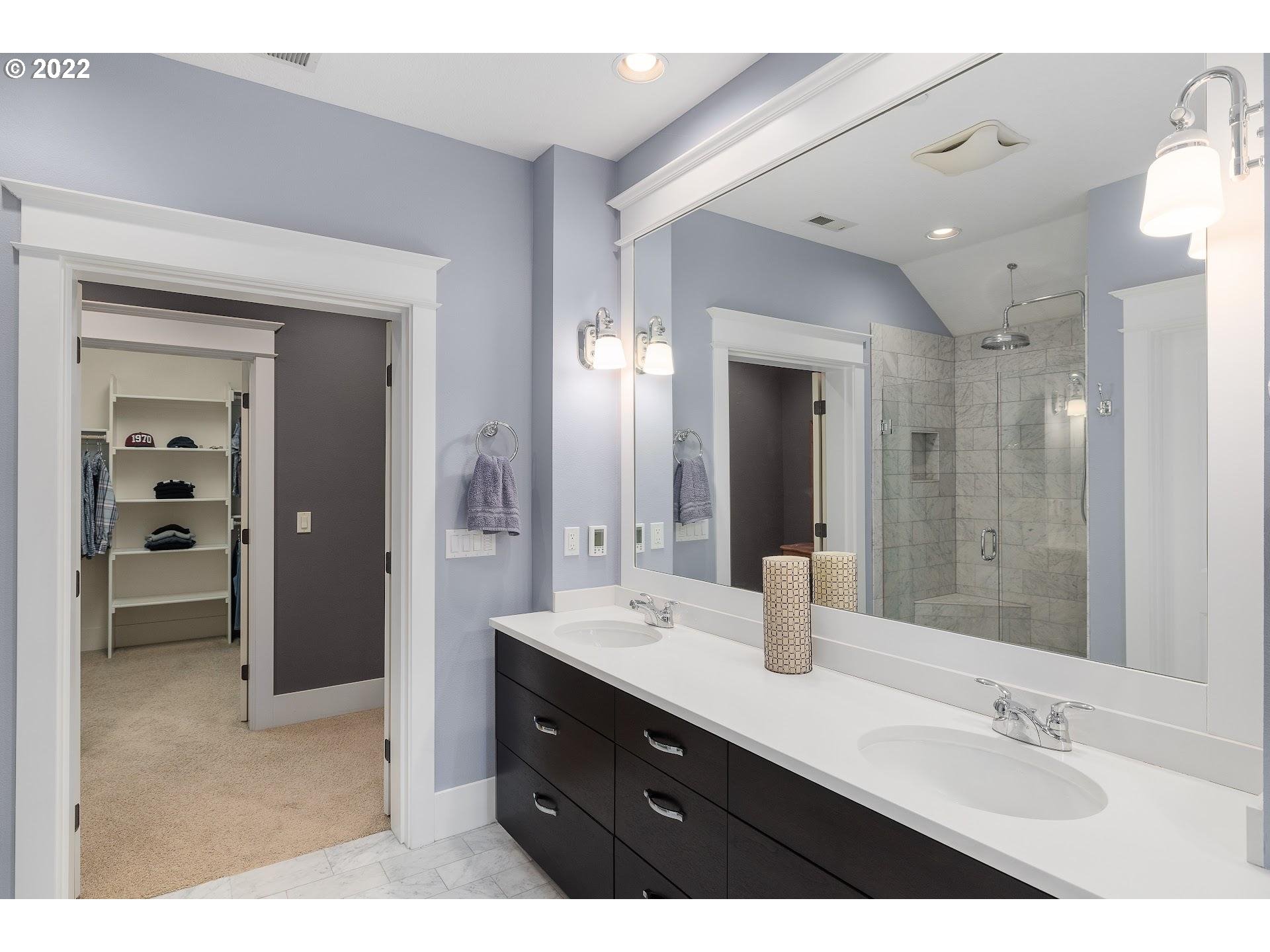 10460 Southwest Windwood Way Portland, OR 97225 - Photo 18 of 29 a bathroom with a double vanity sink mirror and shower
