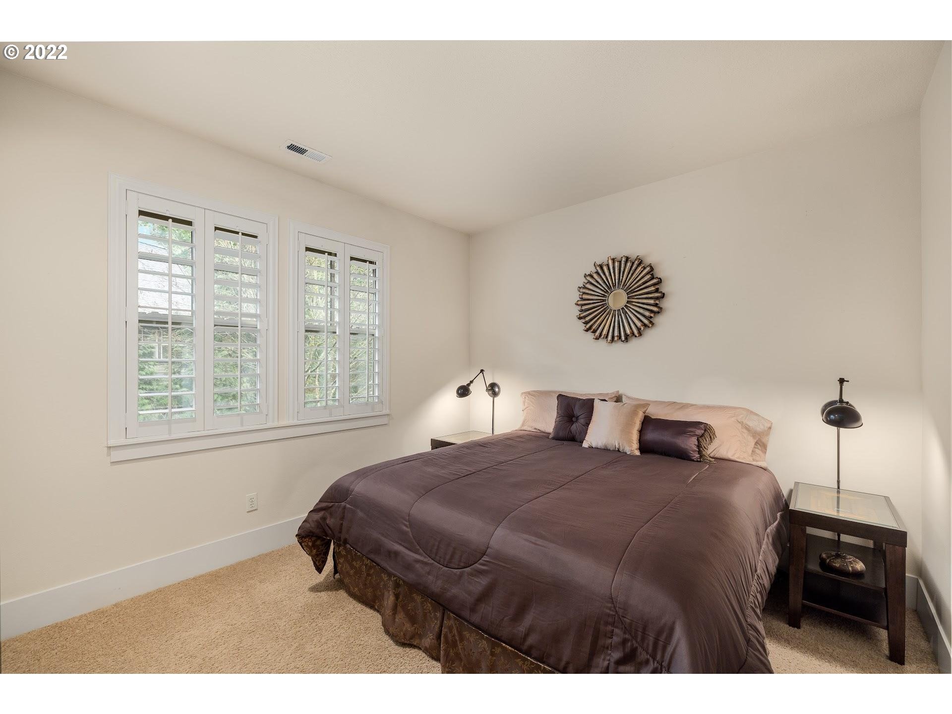 10460 Southwest Windwood Way Portland, OR 97225 - Photo 21 of 29 a bedroom with a bed window and wall painting