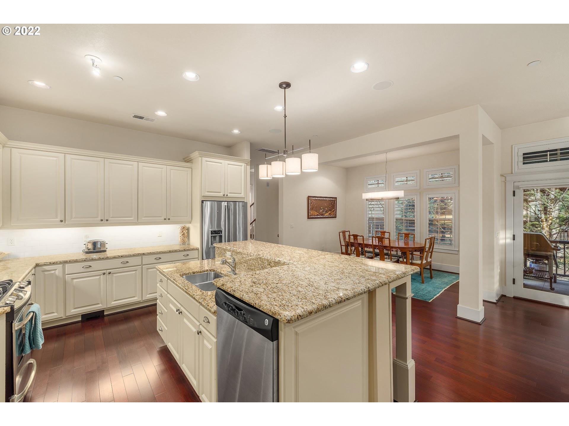 10460 Southwest Windwood Way Portland, OR 97225 - Photo 4 of 29 a kitchen with center island table and chairs