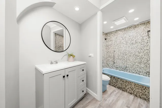 a bathroom with a shower and a sink