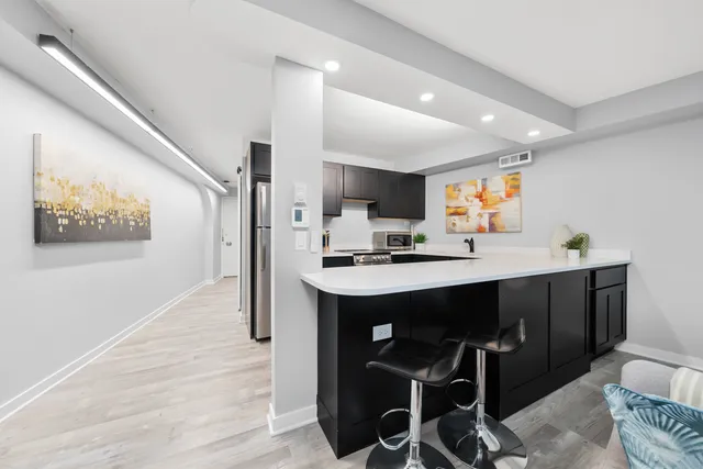 a kitchen with a sink stove and cabinets