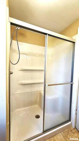 a bathroom with a glass shower door
