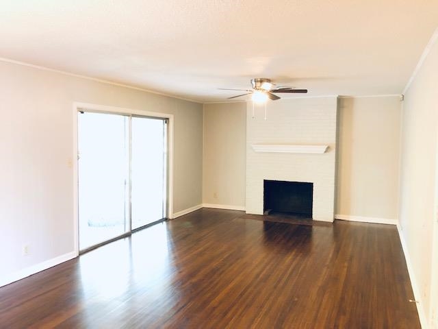 1381 Old Hickory Road Memphis, TN 38116 - Photo 11 of 24 an empty room with wooden floor a fireplace and windows