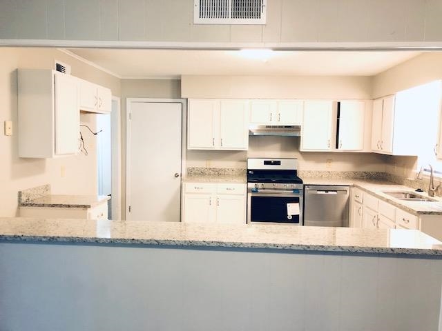 1381 Old Hickory Road Memphis, TN 38116 - Photo 12 of 24 a kitchen with granite countertop a refrigerator and a stove