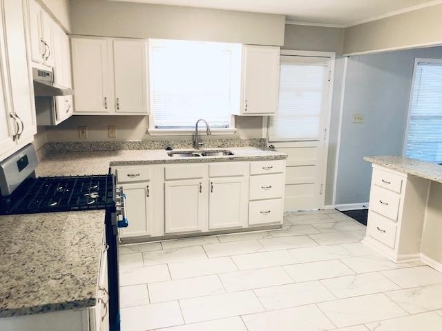 1381 Old Hickory Road Memphis, TN 38116 - Photo 16 of 24 a kitchen with a stove a sink and a refrigerator
