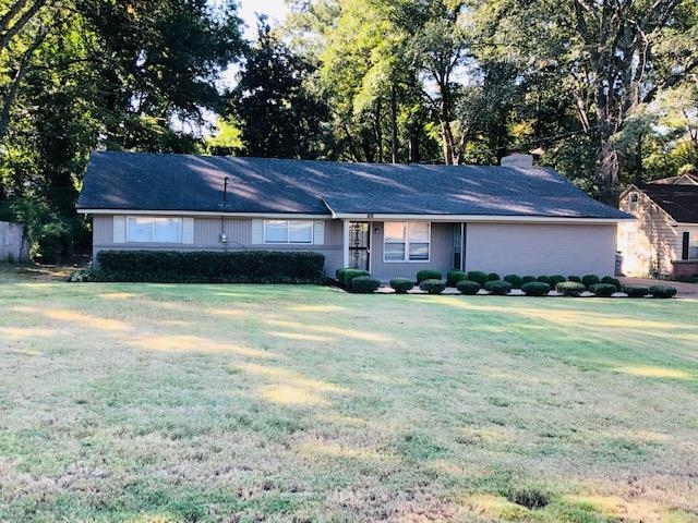 1381 Old Hickory Road Memphis, TN 38116 - Photo 2 of 24 a front view of a house with a garden and trees