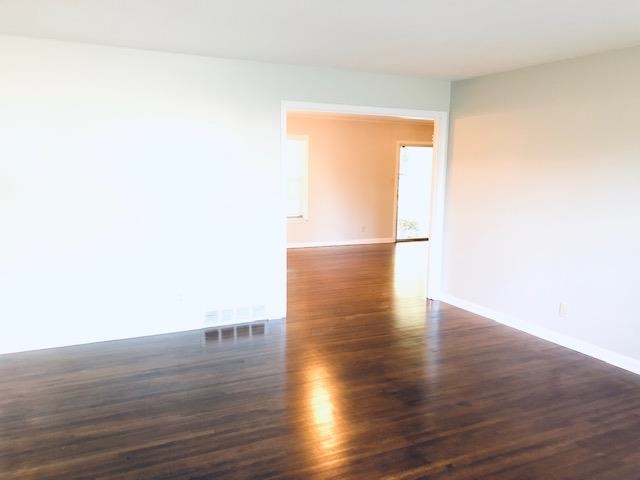 1381 Old Hickory Road Memphis, TN 38116 - Photo 9 of 24 a view of empty room with wooden floor and fence
