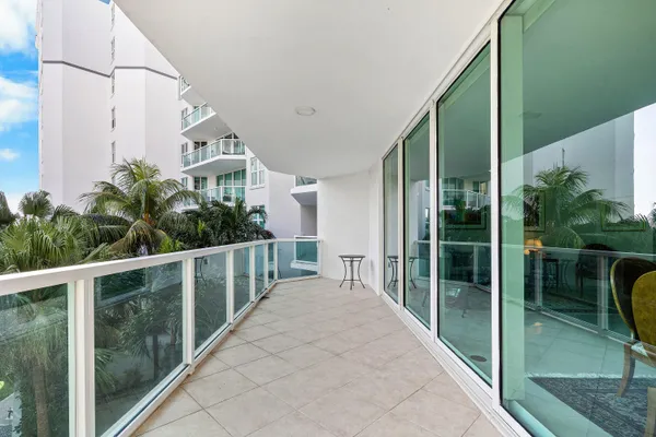 a living room with furniture a rug and a large window