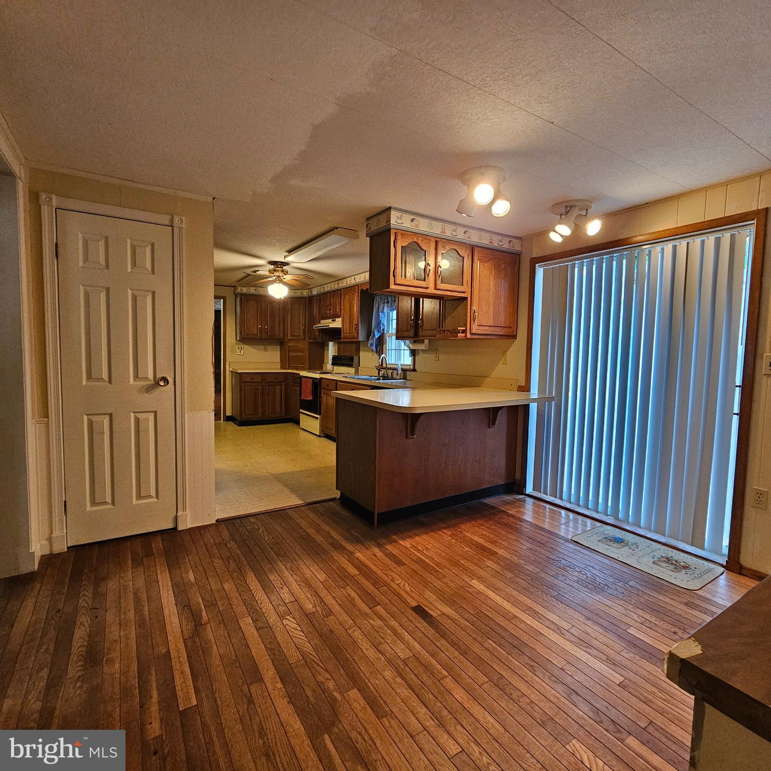 8210 Ingleton Circle Easton, MD 21601 - Photo 5 of 13 a view of a livingroom with wooden floor and furniture