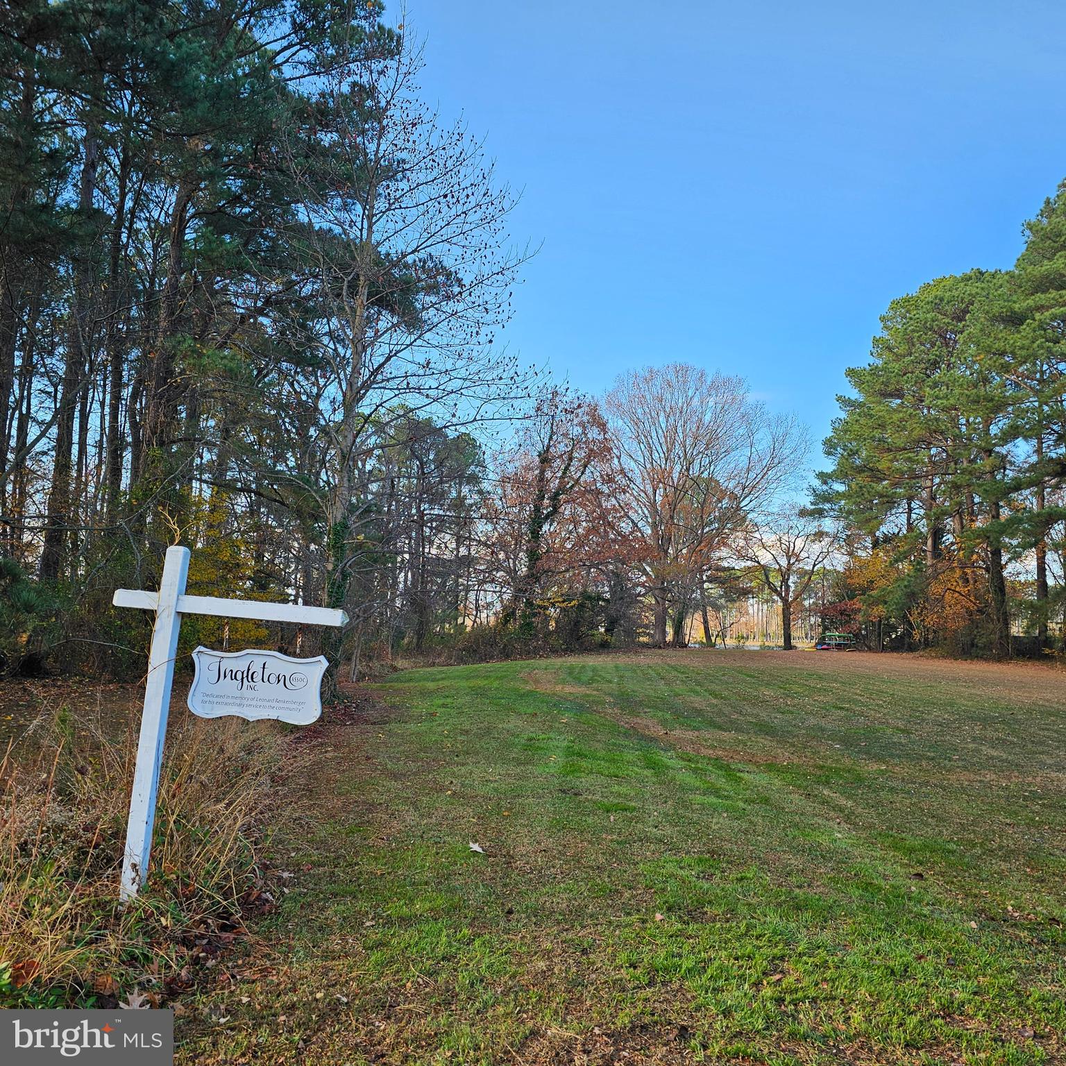 8210 Ingleton Circle Easton, MD 21601 - Photo 7 of 13 a sign board with tall trees in the background