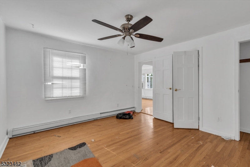 2801 Dewitt Terrace Linden, NJ 07036 - Photo 12 of 23 a view of a room with wooden floor and ceiling fan