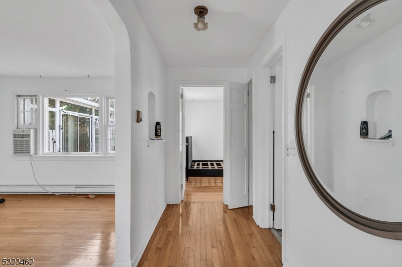 2801 Dewitt Terrace Linden, NJ 07036 - Photo 6 of 23 a view of a hallway with wooden floor and staircase