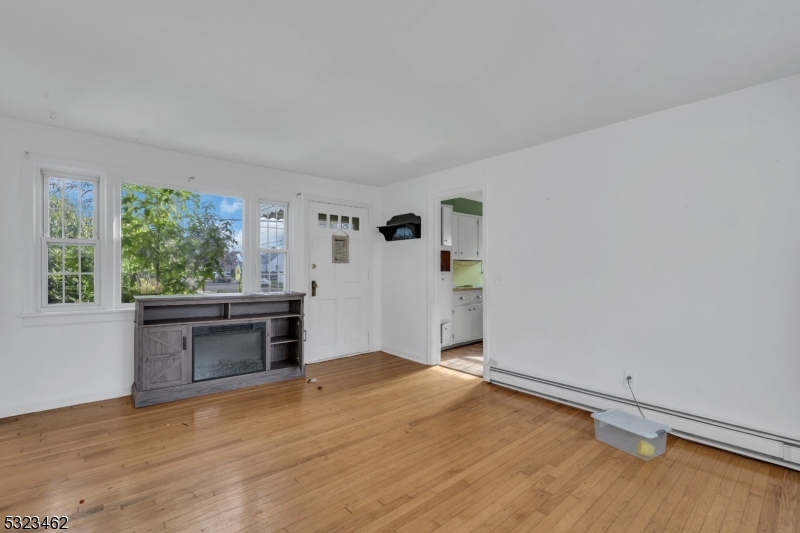 2801 Dewitt Terrace Linden, NJ 07036 - Photo 9 of 23 an empty room with a fireplace and window