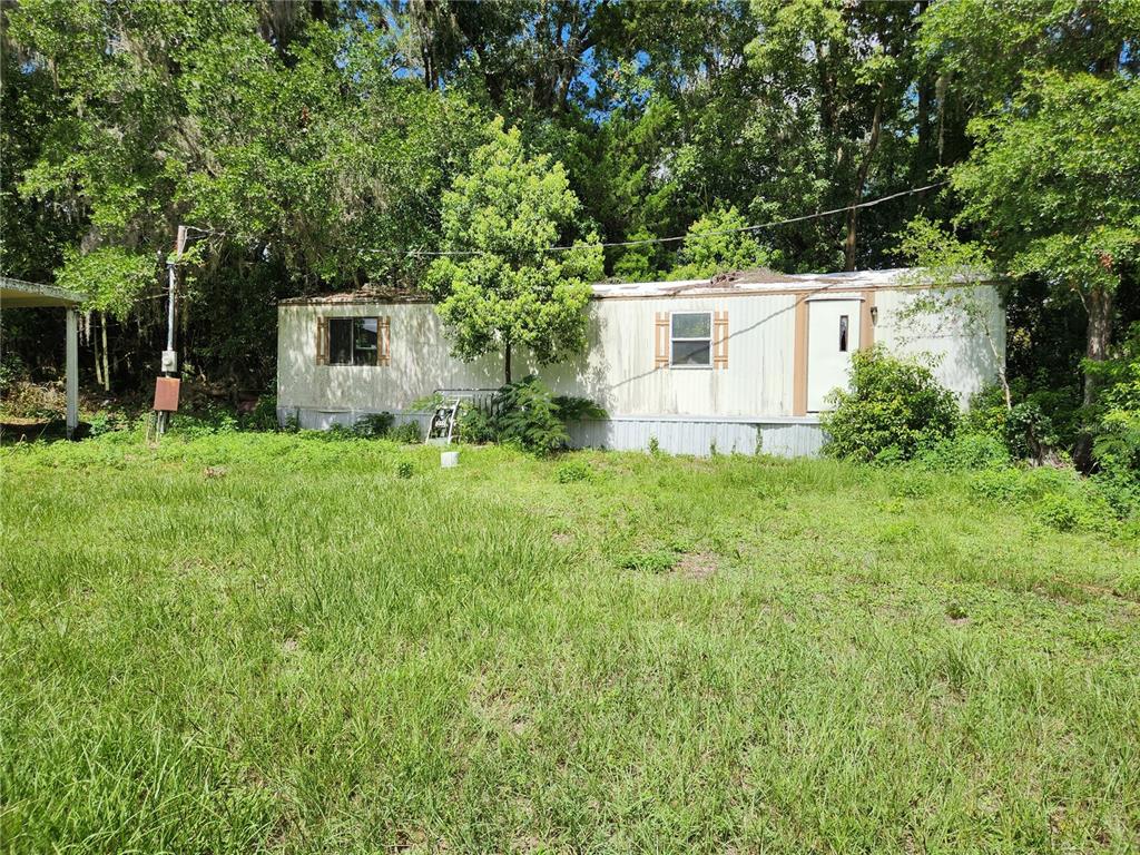 9228 Northeast Jacksonville Road Anthony, FL 32617 - Photo 5 of 8 a view of a house with backyard and sitting area