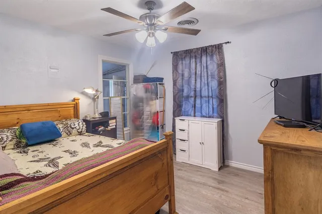 a bedroom with a bed and a television