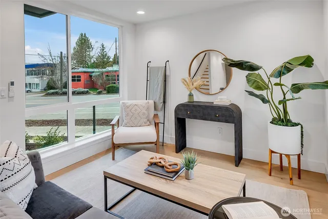a living room with furniture and a potted plant