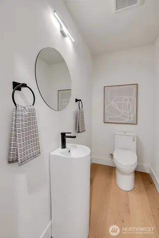 a bathroom with a sink toilet and mirror
