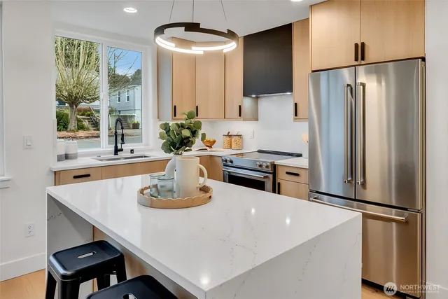 a kitchen with stainless steel appliances a refrigerator and a stove