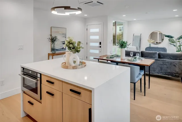 a kitchen with kitchen island a stove and a sink