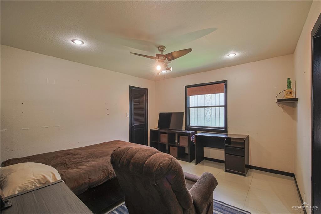 412 Toronto Avenue, Unit 34 McAllen, TX 78503 - Photo 27 of 44 Bedroom with ceiling fan, light tile patterned floors, a textured ceiling, and recessed lighting