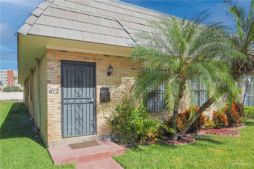 412 Toronto Avenue, Unit 34 McAllen, TX 78503 - Photo 7 of 44 Property entrance featuring brick siding and a yard