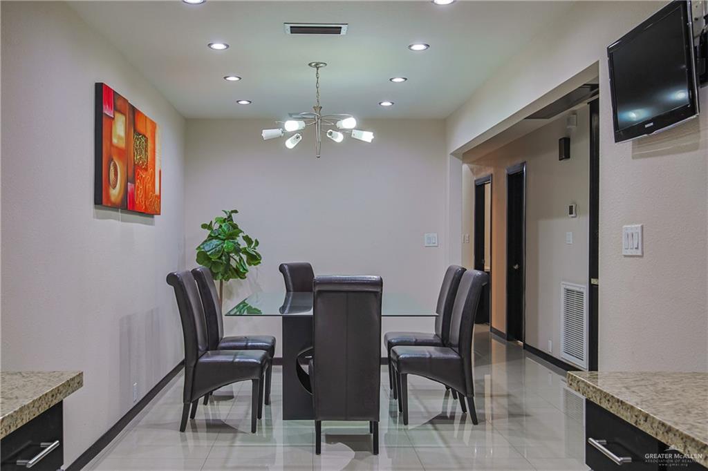 412 Toronto Avenue, Unit 34 McAllen, TX 78503 - Photo 8 of 44 Dining space with recessed lighting, a chandelier, and light tile patterned flooring