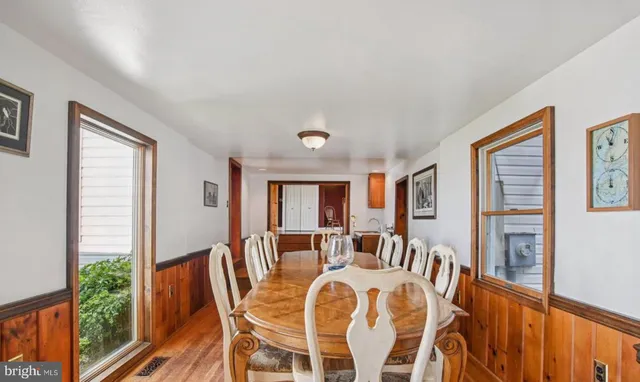 a view of a dining room with furniture window and wooden floor