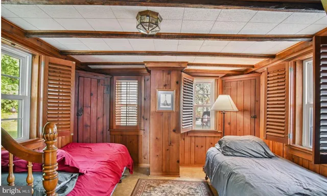 a bedroom with a bed a dresser and a window