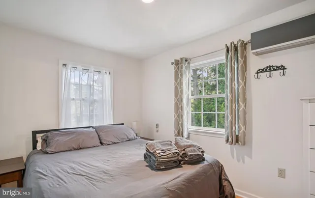 a bedroom with a bed and windows