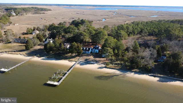an aerial view of a house with beach and outdoor space