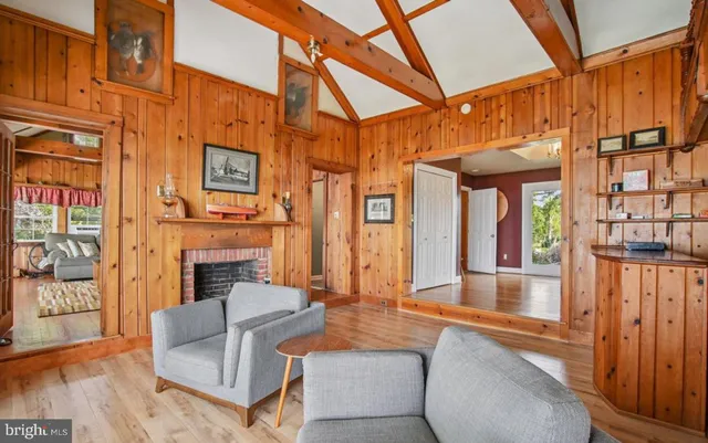 a living room with fireplace furniture and a floor to ceiling window