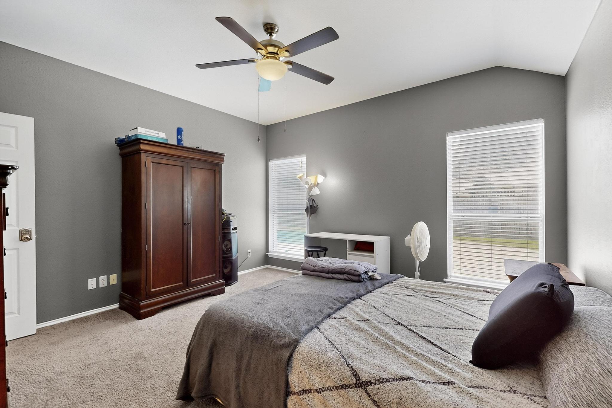 2403 Willow Way Round Rock, TX 78664 - Photo 33 of 35 a bedroom with a bed ceiling fan and a window