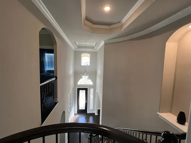 a view of staircase with wooden floor and white walls