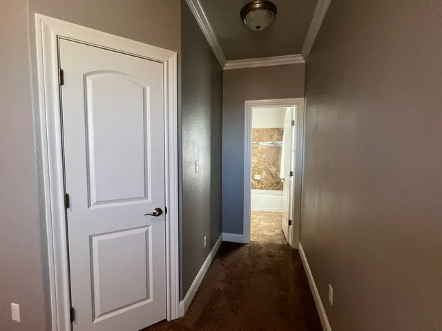 an empty room with closet and a chandelier fan
