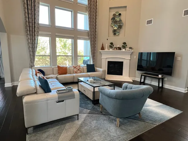 a living room with furniture a fireplace and a flat screen tv