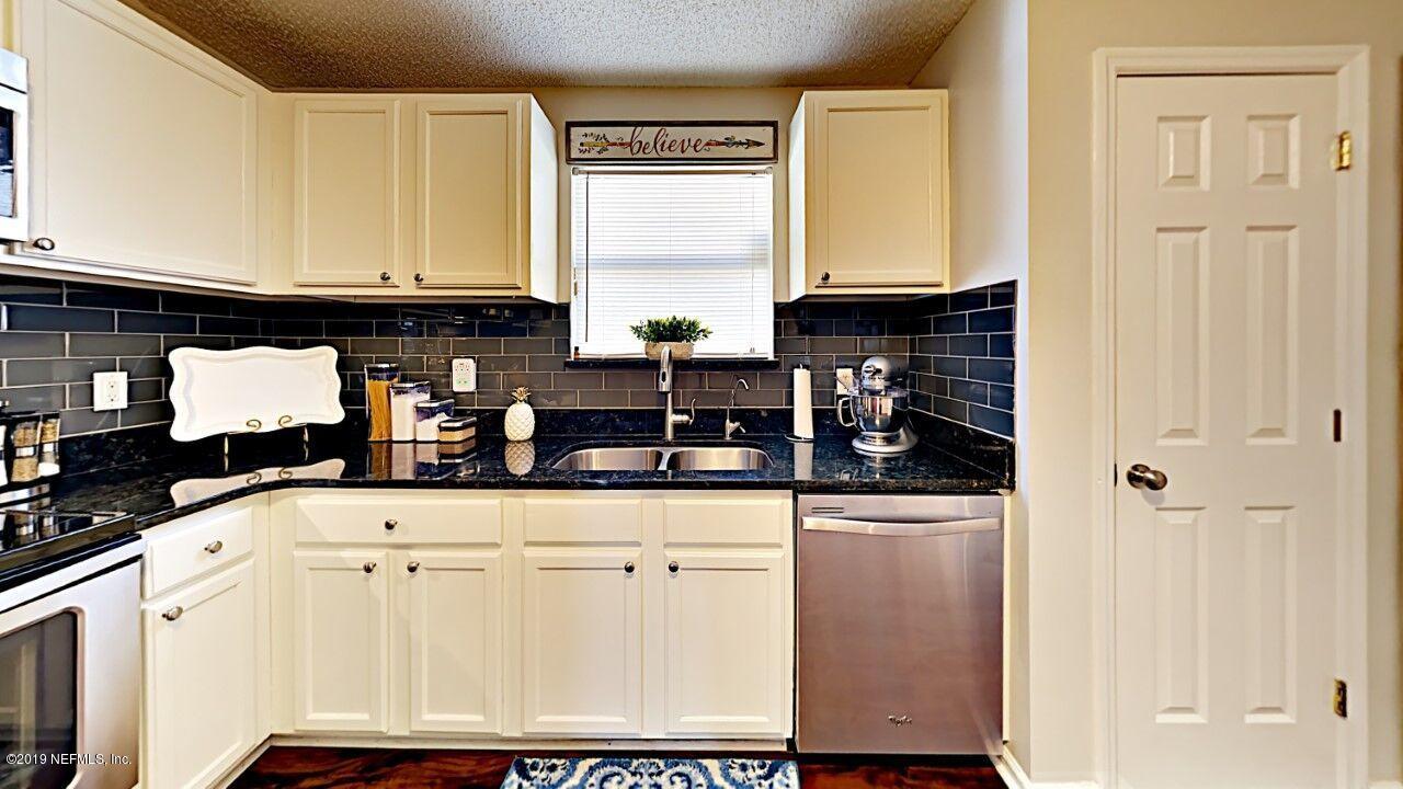 12830 Moose Road Jacksonville, FL 32226 - Photo 15 of 31 a kitchen with granite countertop a sink a stove and cabinets