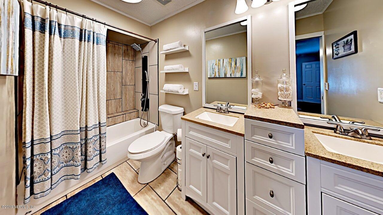 12830 Moose Road Jacksonville, FL 32226 - Photo 20 of 31 a spacious bathroom with a double vanity sink toilet mirror and bathtub