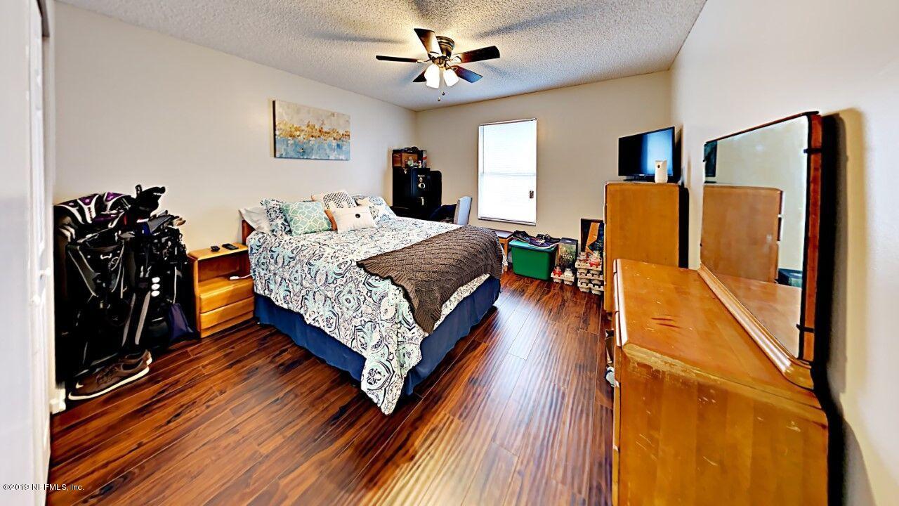 12830 Moose Road Jacksonville, FL 32226 - Photo 23 of 31 a bedroom with bed and wooden floor