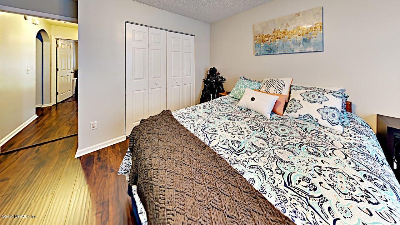 12830 Moose Road Jacksonville, FL 32226 - Photo 24 of 31 a bedroom with a bed and a painting on the wall