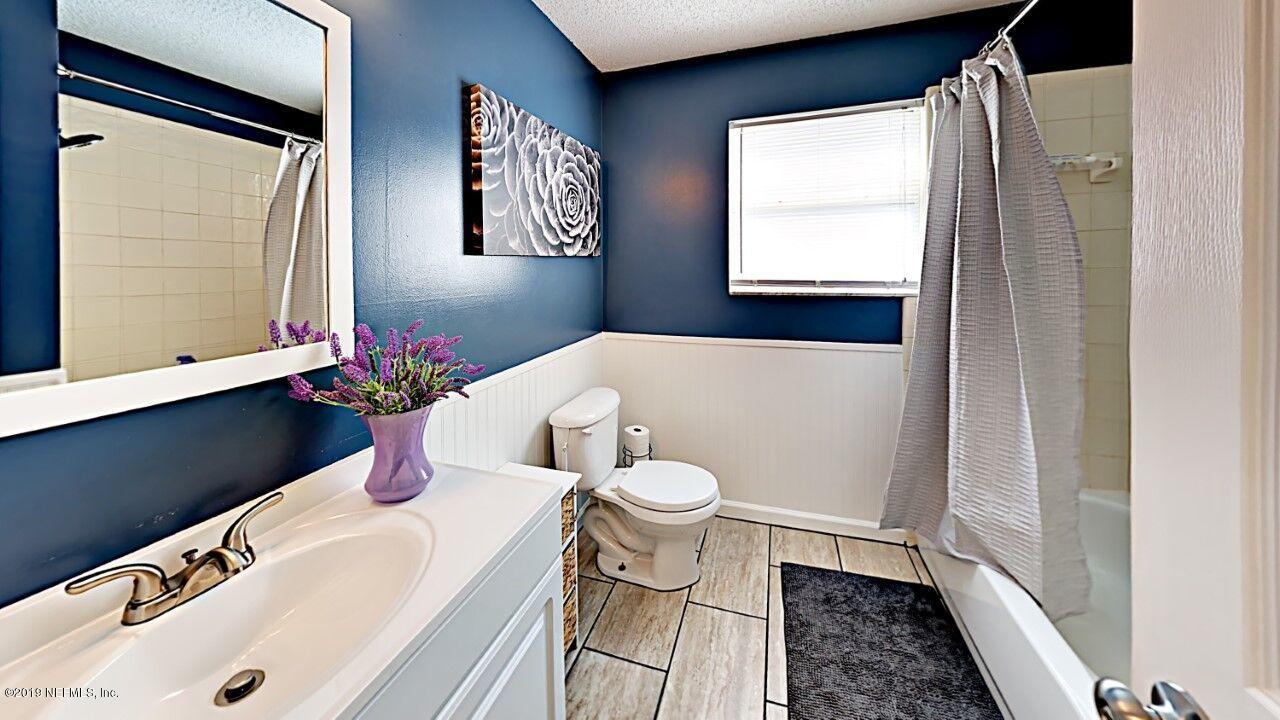 12830 Moose Road Jacksonville, FL 32226 - Photo 25 of 31 a bathroom with a sink and a mirror