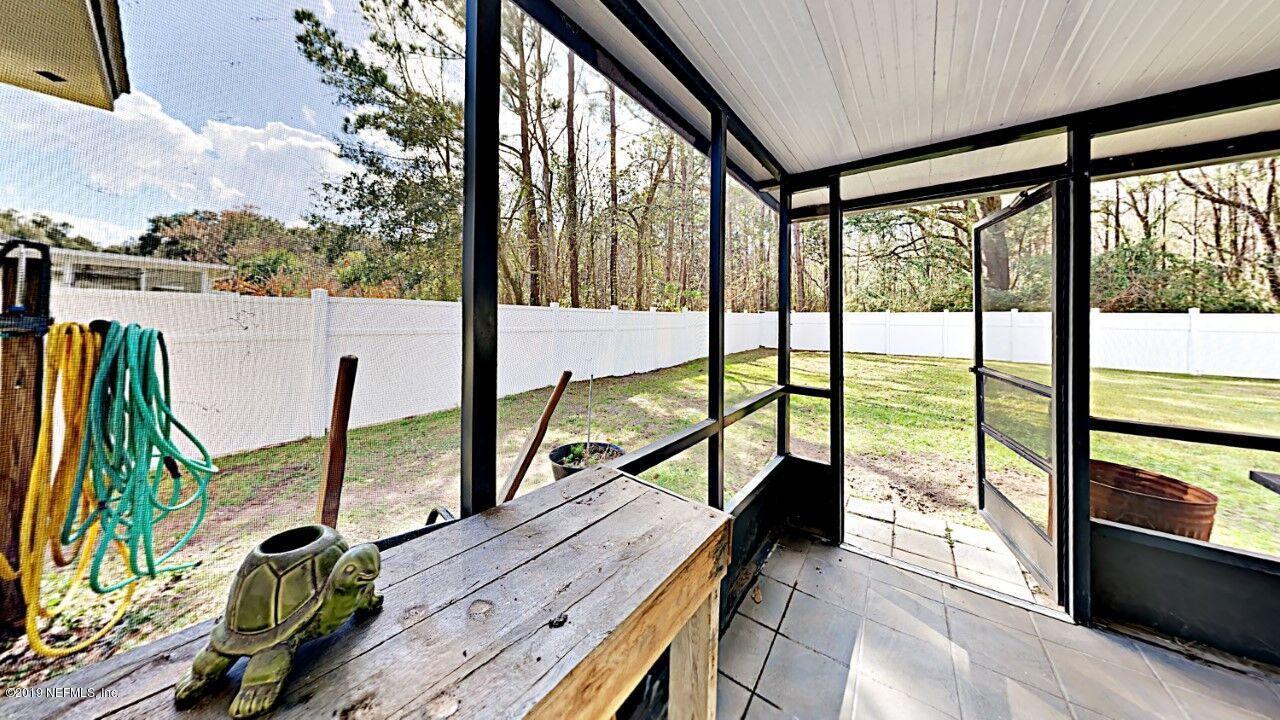 12830 Moose Road Jacksonville, FL 32226 - Photo 29 of 31 a view of a balcony with chairs and wooden floor