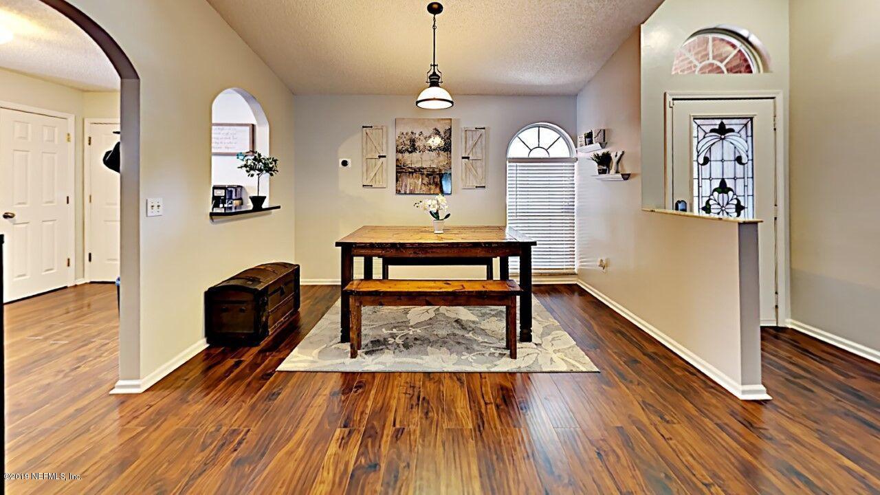 12830 Moose Road Jacksonville, FL 32226 - Photo 4 of 31 a living room with furniture and a wooden floor