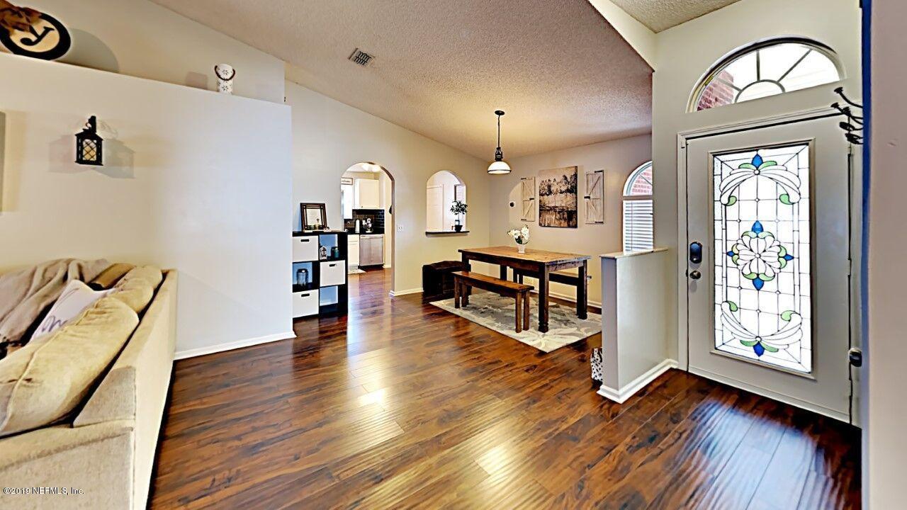 12830 Moose Road Jacksonville, FL 32226 - Photo 6 of 31 a view of a livingroom with furniture and hardwood floor