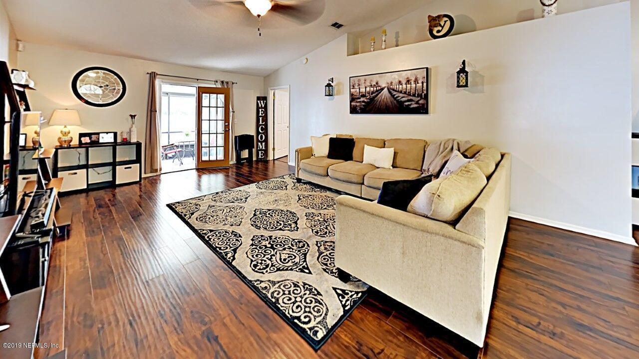 12830 Moose Road Jacksonville, FL 32226 - Photo 7 of 31 a living room with furniture and a wooden floor